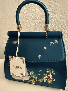 Fable England dark green mini handbag with embroidered design.